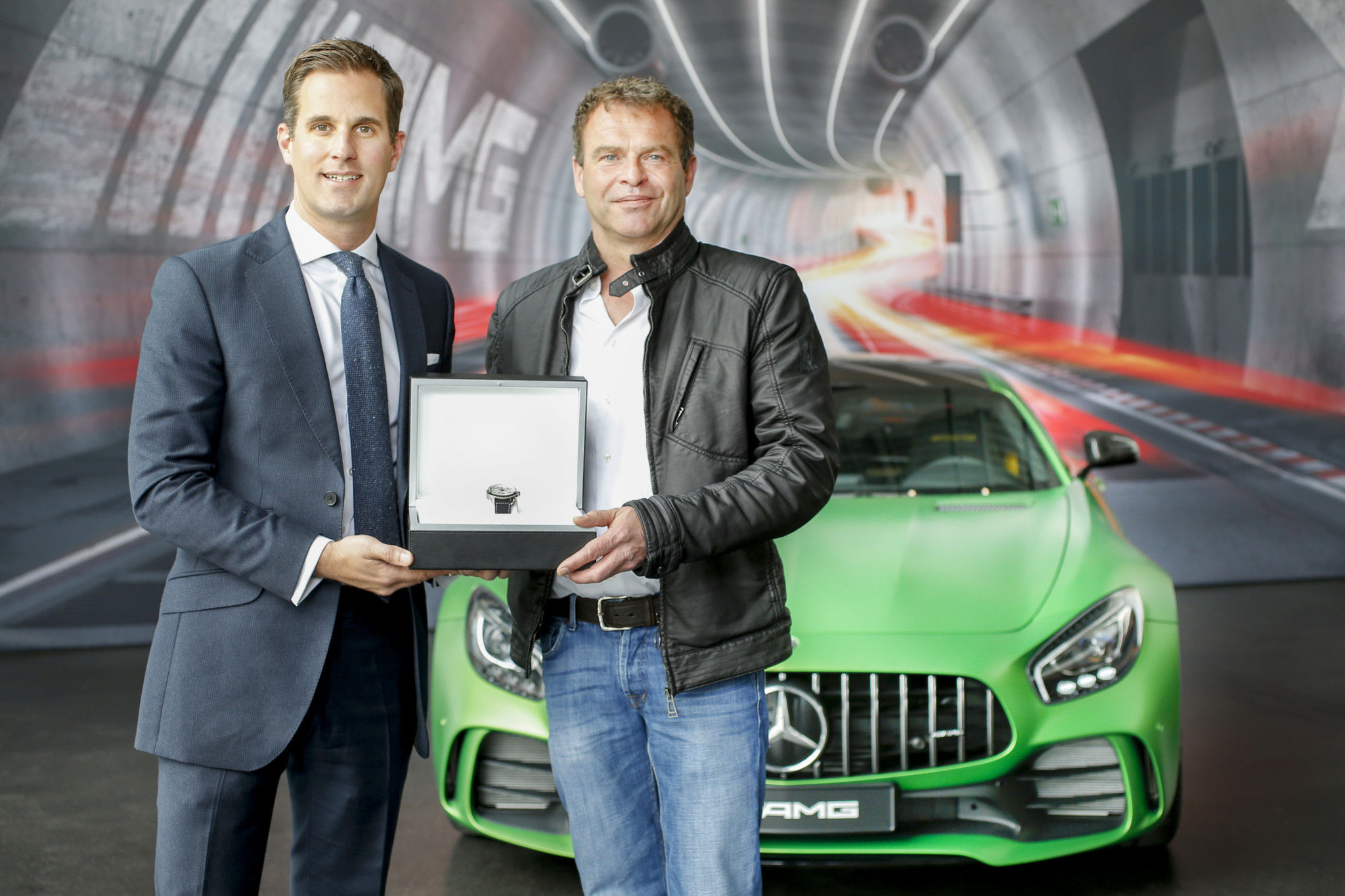IWC CEO Christoph Grainger-Herr visits the AMG manufacture in Affalterbach and hands over the Ingenieur Chronograph Sport Edition "50th Anniversary of Mercedes-AMG" to AMG CEO Tobias Moers.