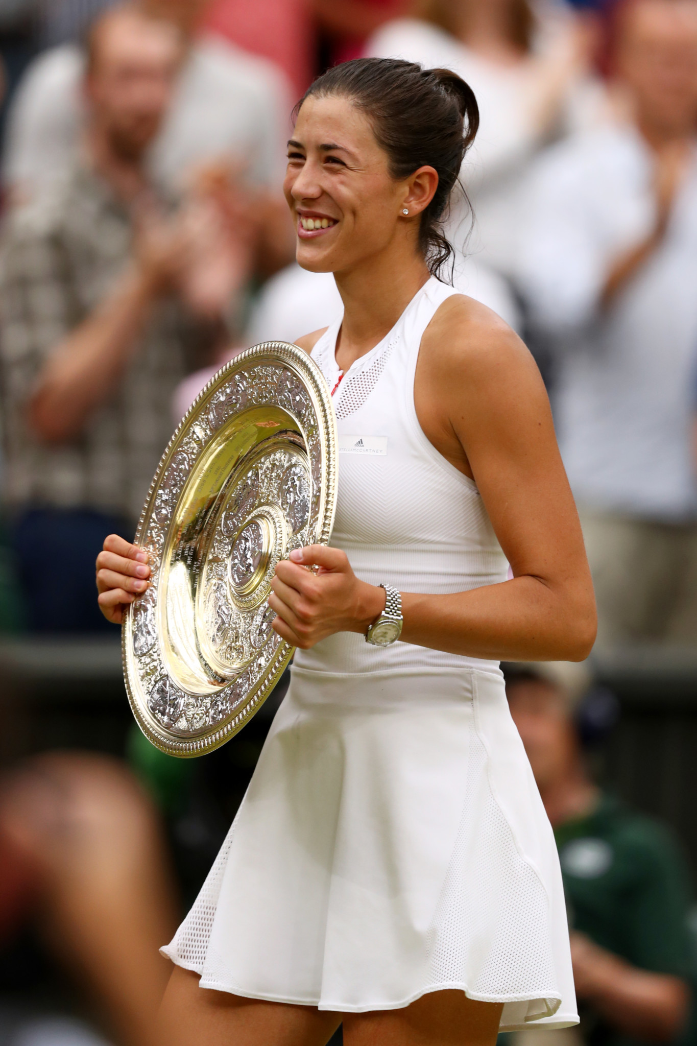 Garbine Muguruza of Spain celebrates victory with the trophy after the Ladies Singles final against Venus Williams. (Photo by Michael Steele/Getty Images)
